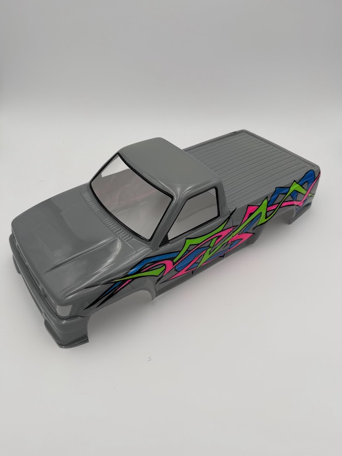 Gray custom RC pickup body with bright pink, blue, green, and black graphics